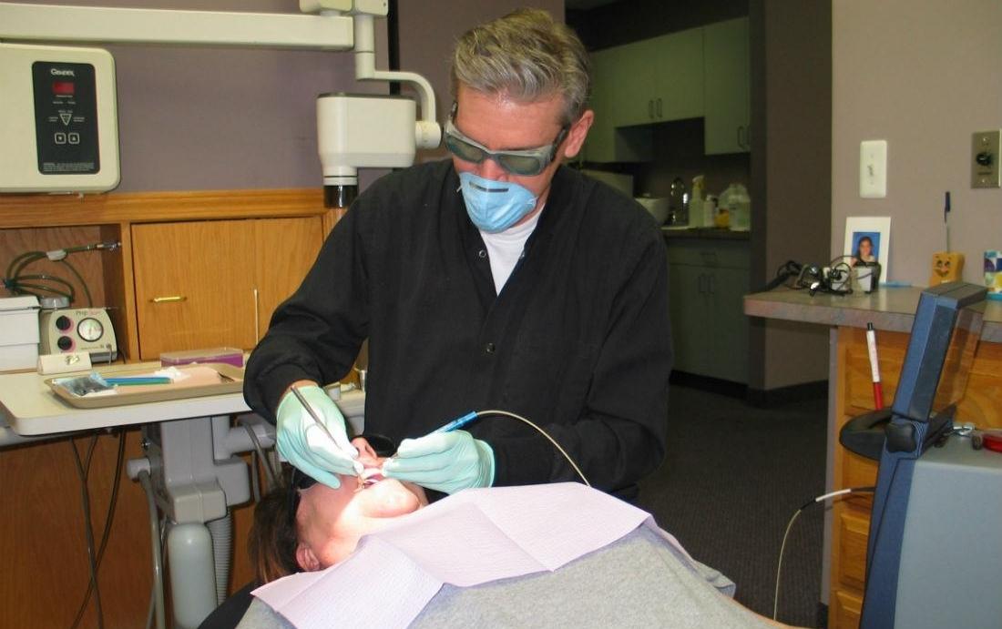 Dr. Aiello using laser to perform LANAP or using PerioLase Laser. Clinton Township